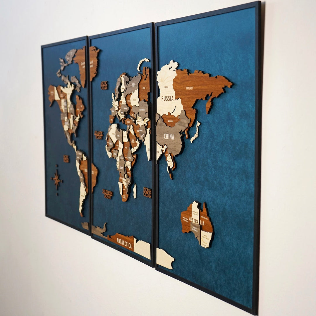 Angled side view of the three-panel wooden world map showing layered continents on blue panels