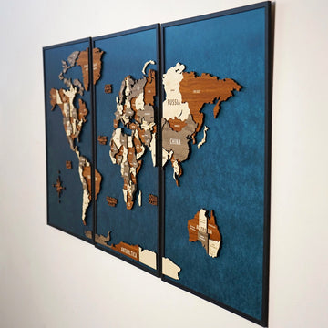 Angled side view of the three-panel wooden world map showing layered continents on blue panels