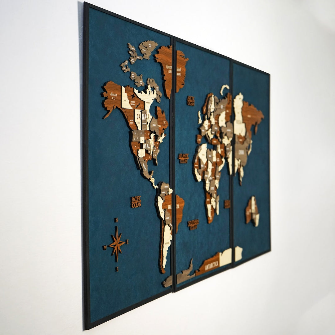 Steep side angle of the three-panel framed wooden world map showing layered depth
