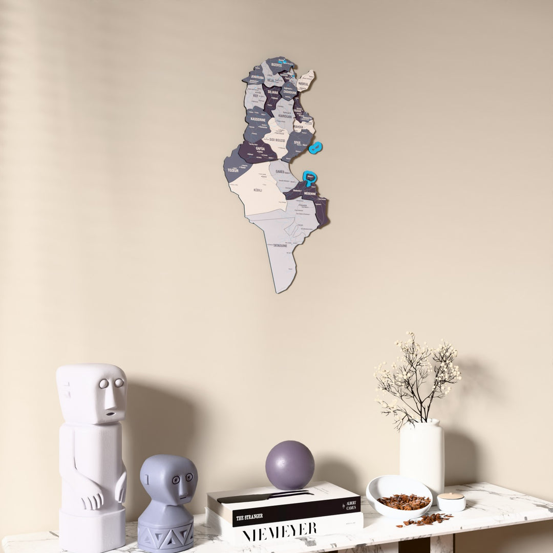 Nimbus Tunisia wooden wall map on a beige wall above a console with figurines