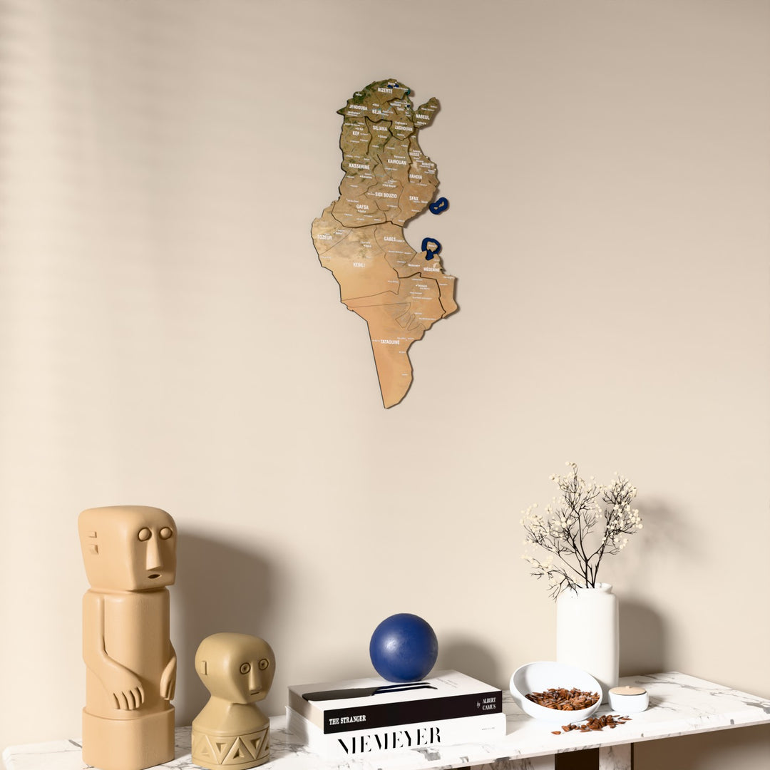 Satellite Tunisia wooden wall map on a beige wall above a console with figurines