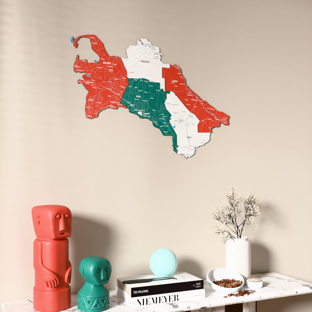 Flag colored Turkmenistan wooden wall map on a beige wall above a console with figurines
