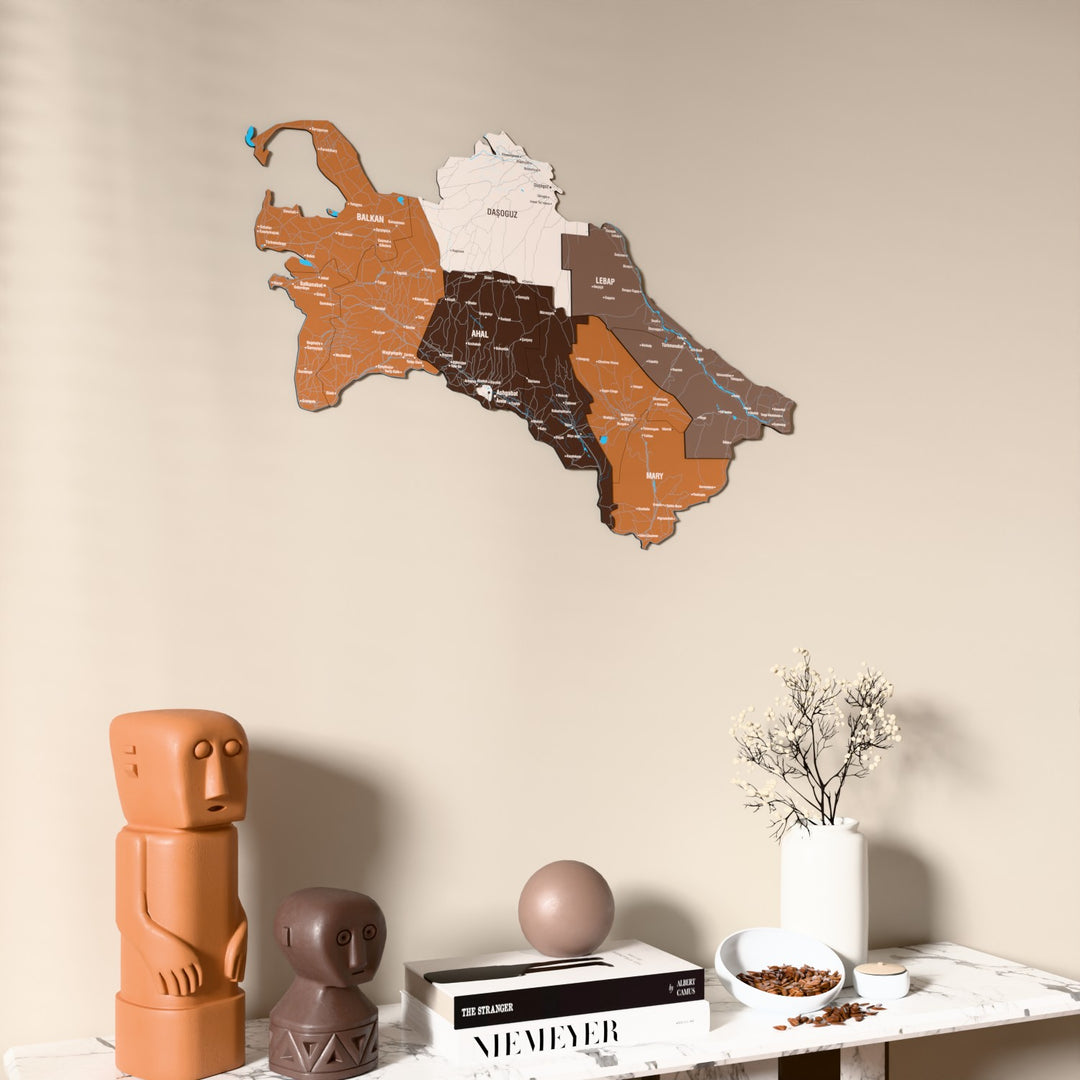 Soil Turkmenistan wooden wall map on a beige wall above a console with figurines