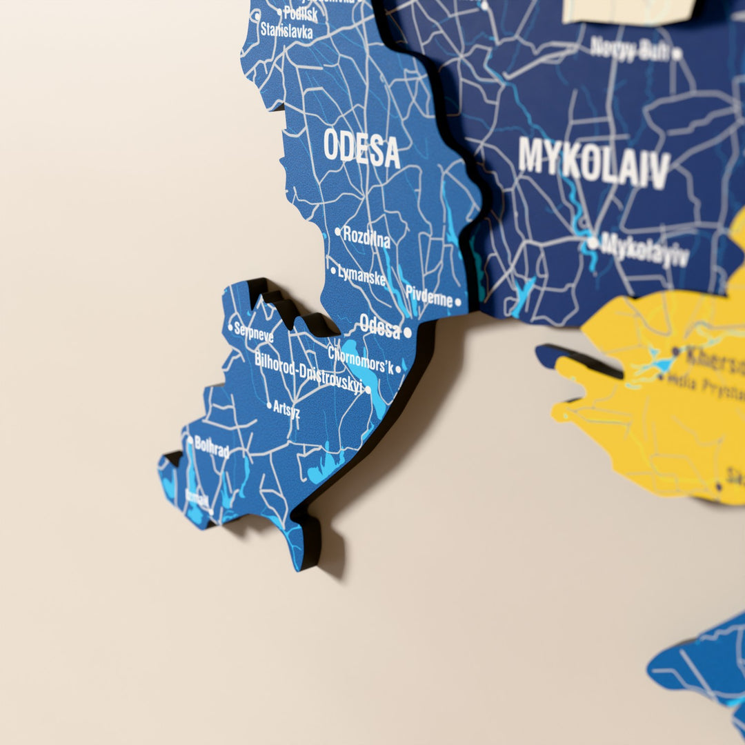 Close-up of the Flag colored Ukraine wooden wall map with layered regions and printed names