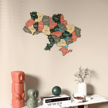 Sage Ukraine wooden wall map on a beige wall above a console with figurines