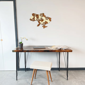 Small Ukraine wooden wall map above a console table with a white stool, full-room view