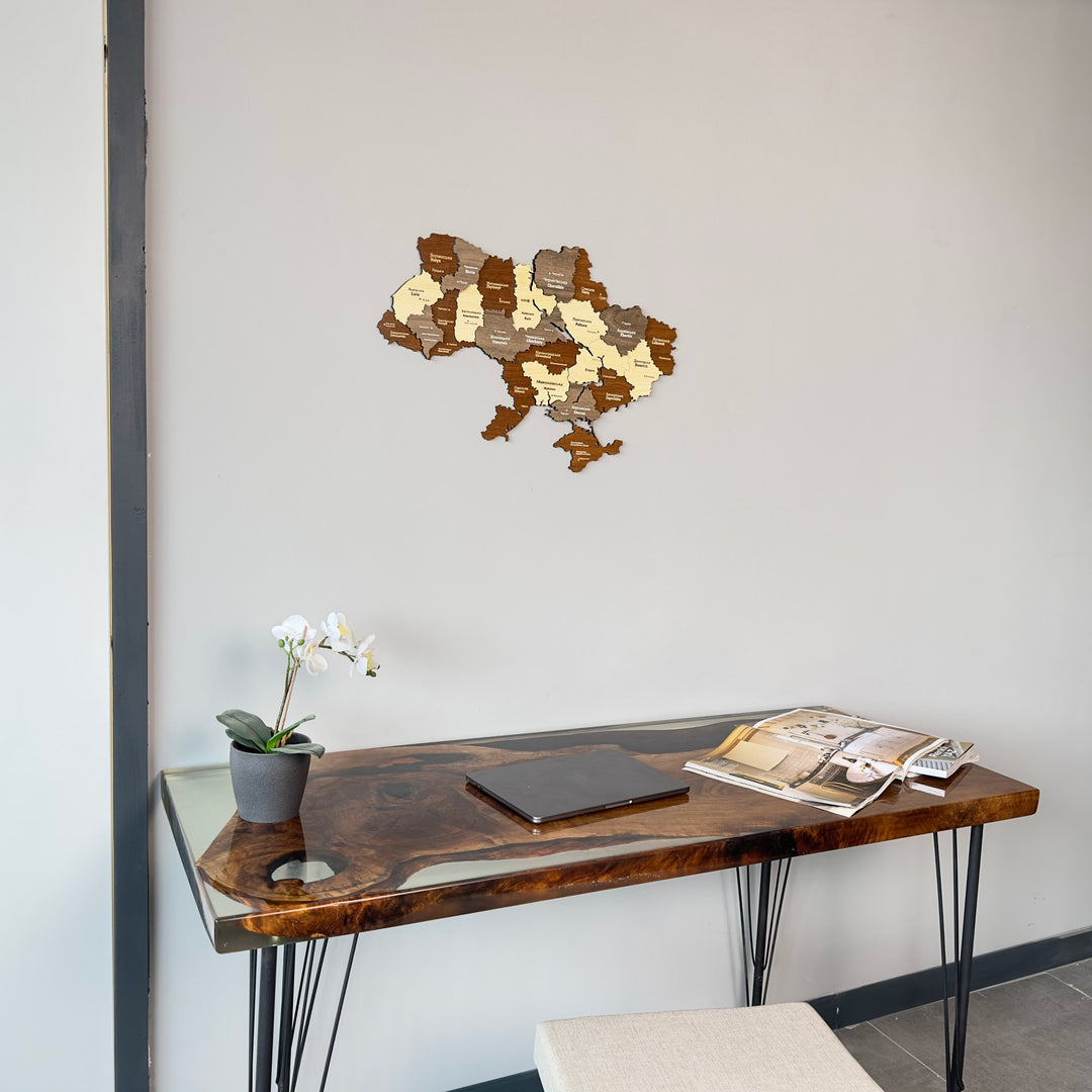 Ukraine wooden wall map hung above a desk with an orchid, centered view