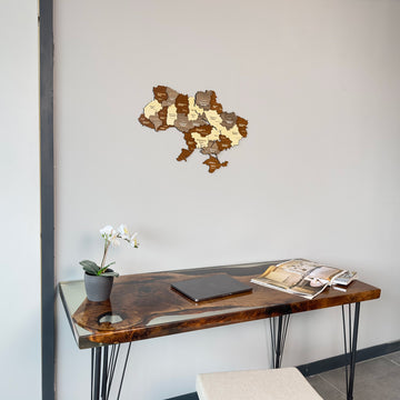 Ukraine wooden wall map hung above a desk with an orchid, centered view