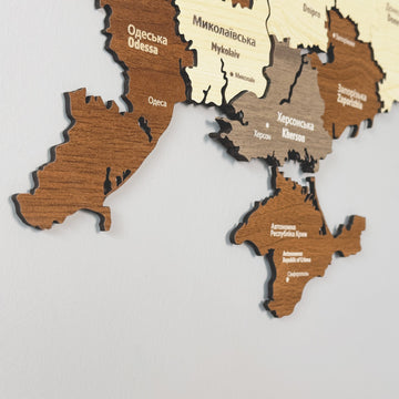 Close-up of Ukraine wooden map layers showing Odesa, Mykolaiv, Kherson and Crimea in Ukrainian and English