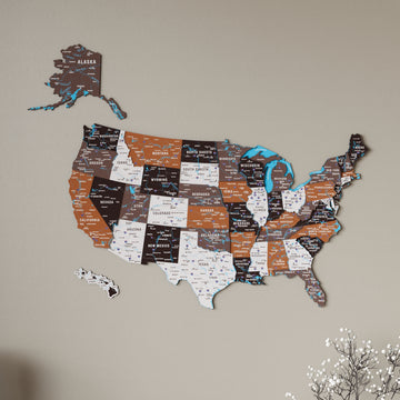 Soil colored United States wooden wall map, slightly angled close view with blue lakes and white flowers at the corner