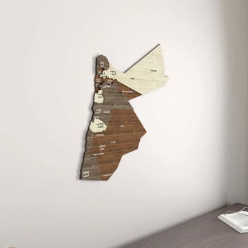 Jordan wooden wall map in a room corner above a desk with an open book, wide view