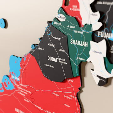 Close-up of the Flag colored United Arab Emirates wooden wall map with layered regions and printed names