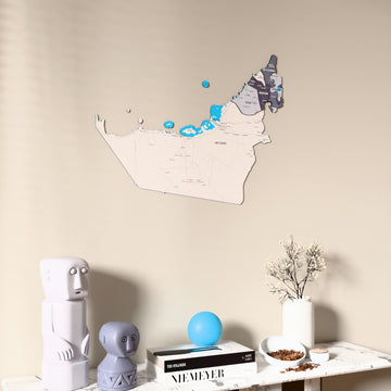 Nimbus United Arab Emirates wooden wall map on a beige wall above a console with figurines
