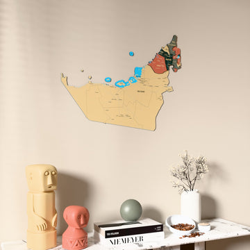 Sage United Arab Emirates wooden wall map on a beige wall above a console with figurines