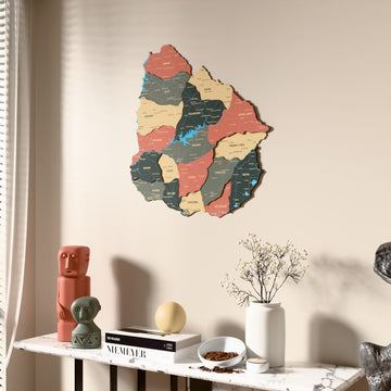 Sage Uruguay wooden wall map beside a sheer curtain, angled view