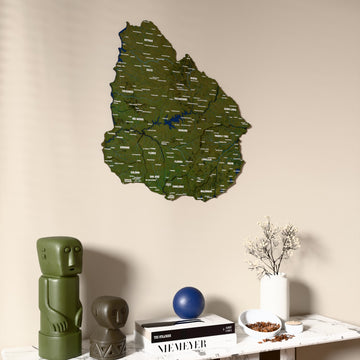 Satellite Uruguay wooden wall map on a beige wall above a console with figurines