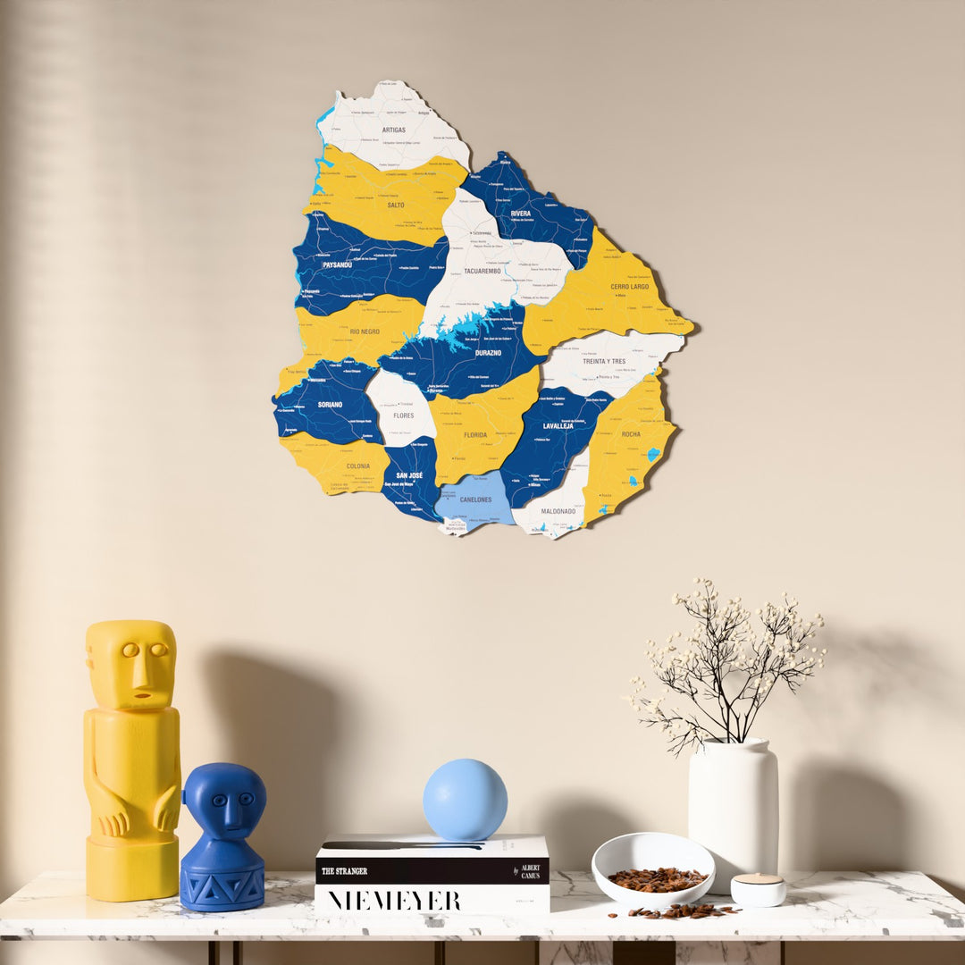 Flag colored Uruguay wooden wall map above a marble console, front view