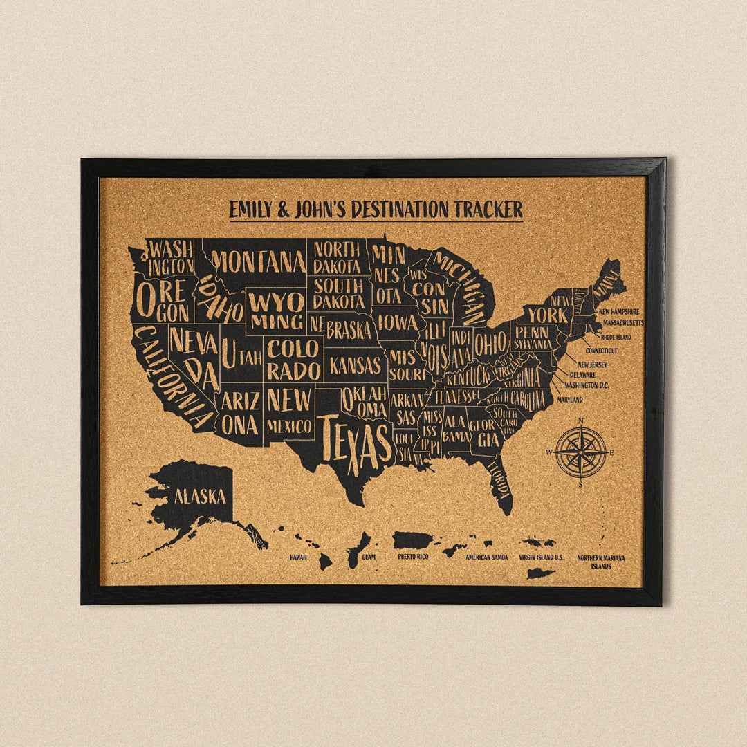 Black-framed cork USA map with state names printed in black, titled Emily & John's Destination Tracker, front view