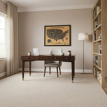 Framed cork USA map on a home office wall, wide room view with desk, bookcase and window