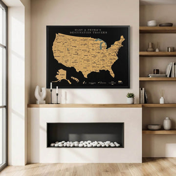 Black framed cork USA map with a personalized title above a modern fireplace with built-in shelves