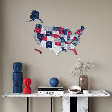 Flag colored United States wooden wall map in red, navy and gray above a marble console with a blue figurine, wide view