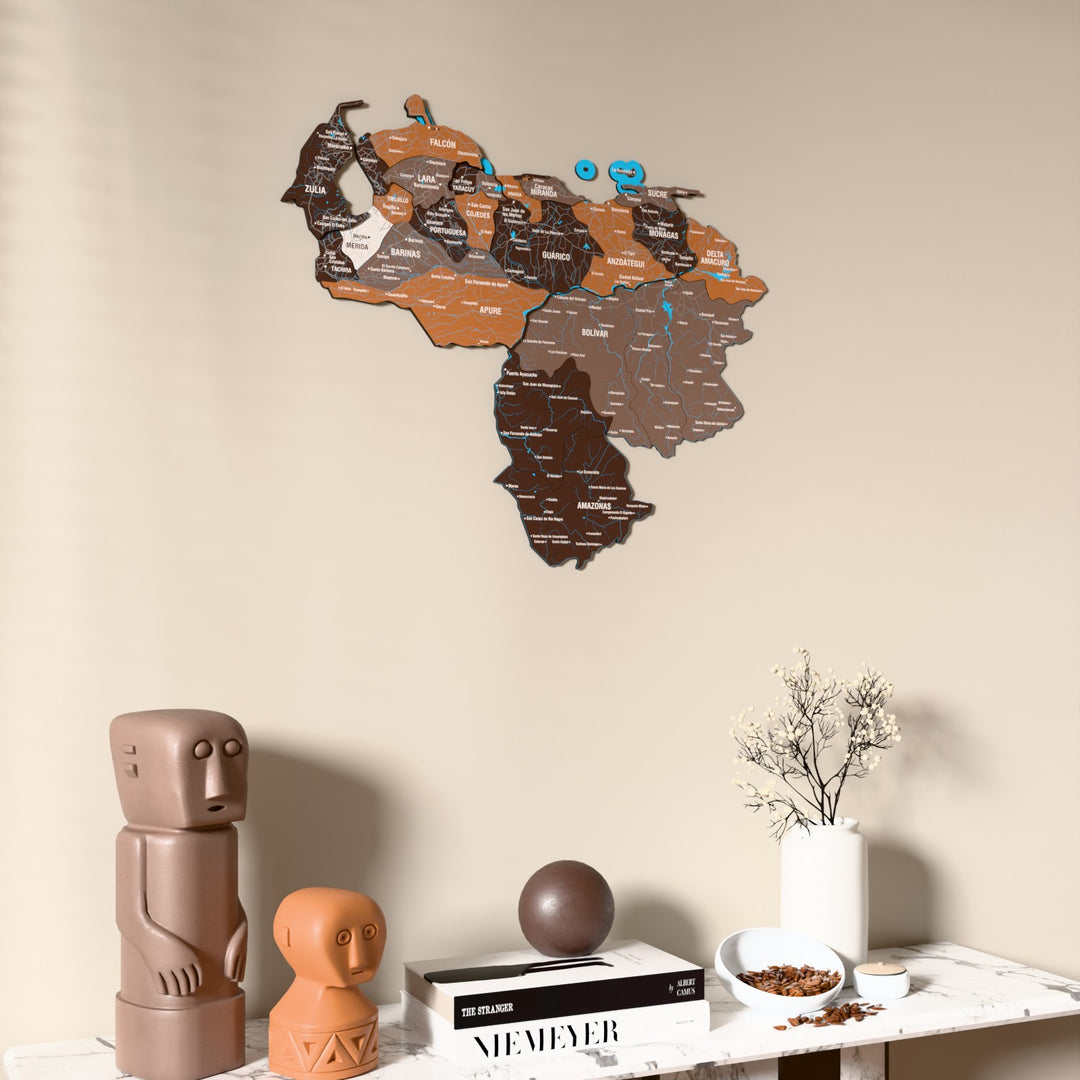Soil Venezuela wooden wall map on a beige wall above a console with figurines