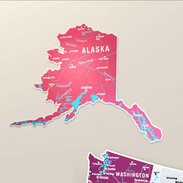 Close-up of the separate Alaska piece of the crimson metal USA map, with rivers, cities and Washington below