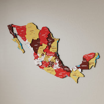 Terra Mexico wooden wall map in red, maroon and mustard states on a beige wall, angled view showing the layered pieces