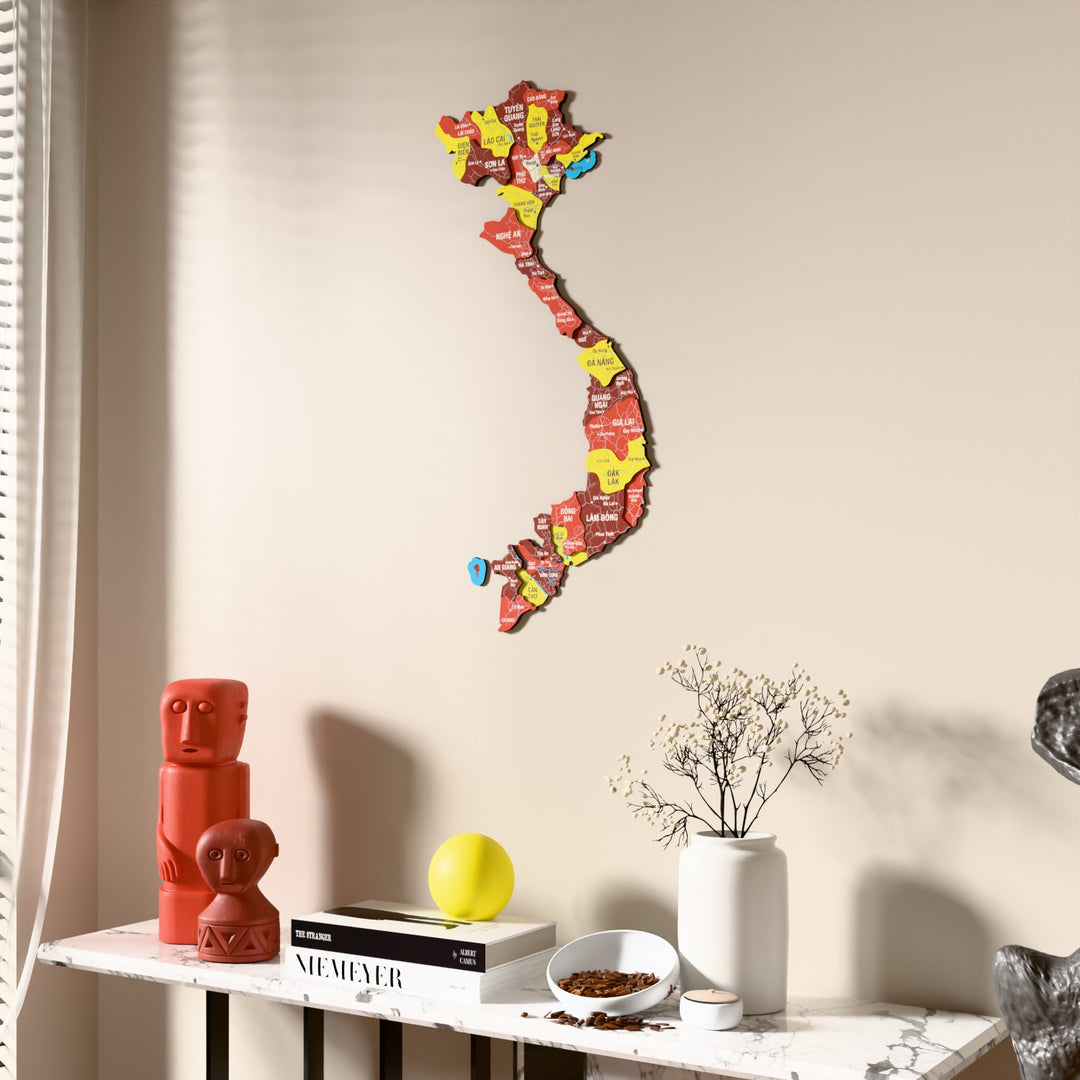 Flag colored Vietnam wooden wall map beside a sheer curtain, angled view
