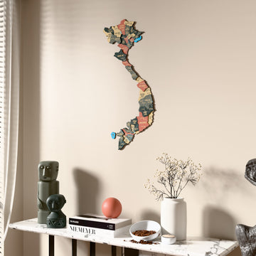 Sage Vietnam wooden wall map beside a sheer curtain, angled view