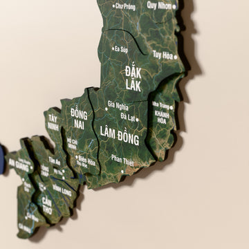 Close-up of the Satellite Vietnam wooden wall map with layered regions and printed names