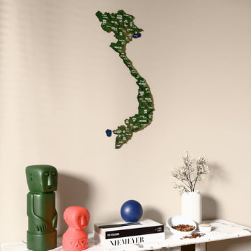 Satellite Vietnam wooden wall map on a beige wall above a console with figurines