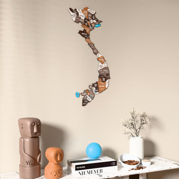 Soil Vietnam wooden wall map on a beige wall above a console with figurines