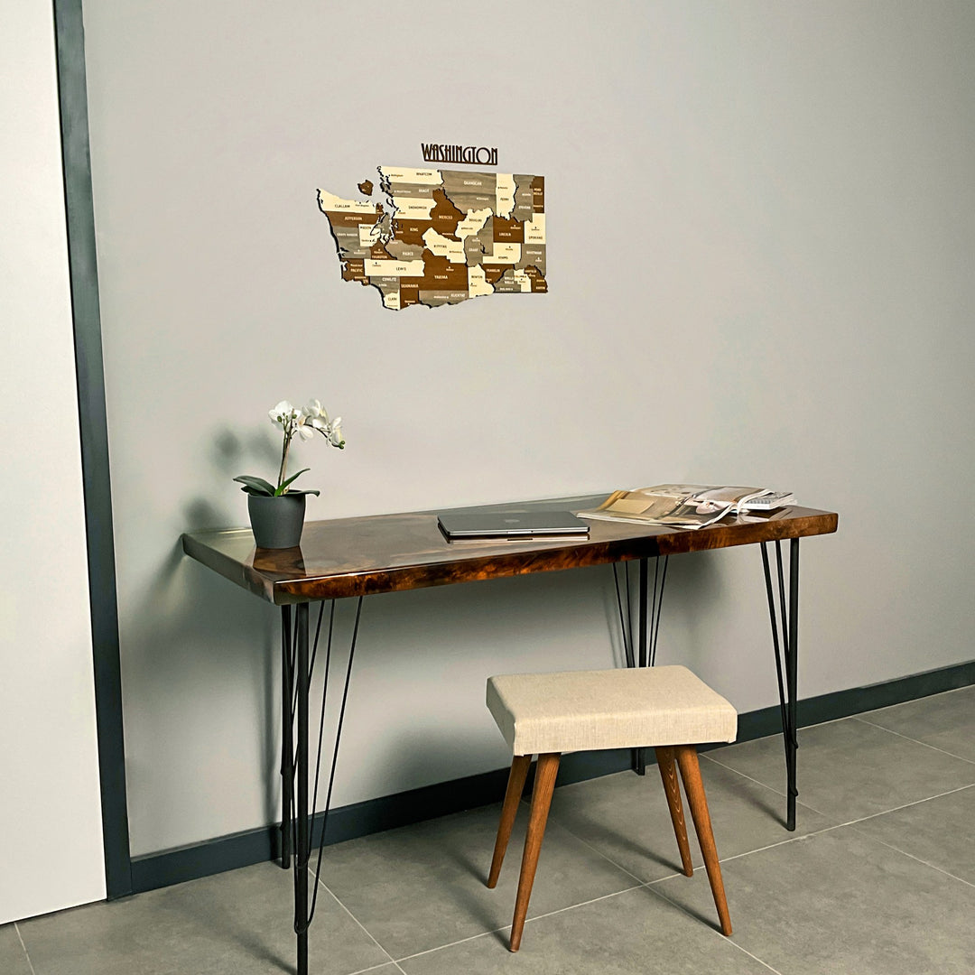 Small Washington State wooden wall map above a desk and stool, view from the right side