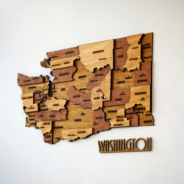Washington State wooden county map on a white wall with WASHINGTON lettering, near front view