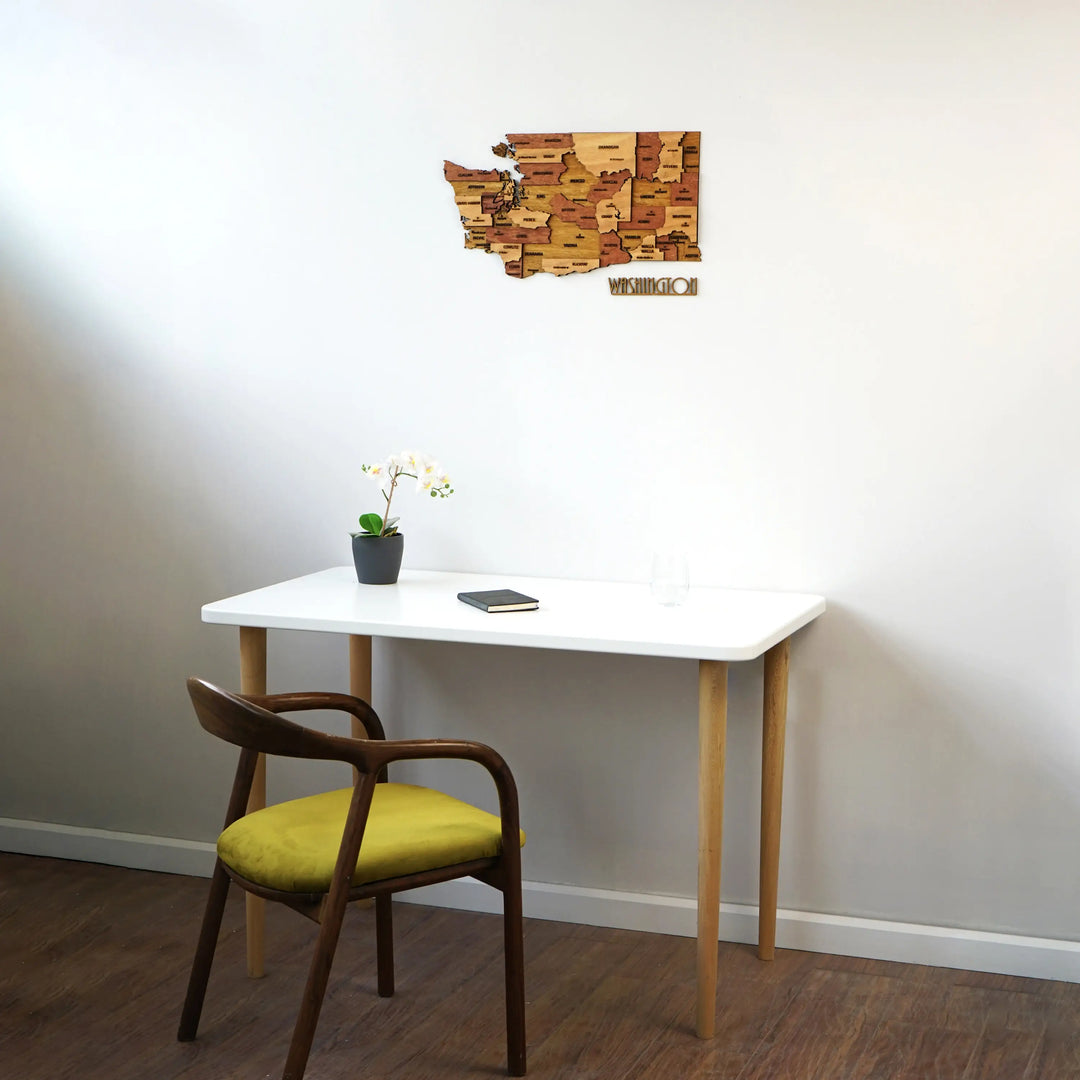 Washington wooden map above a white desk and chair in a room corner, angled wide view