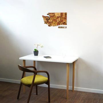 Washington wooden map above a white desk and chair in a room corner, angled wide view