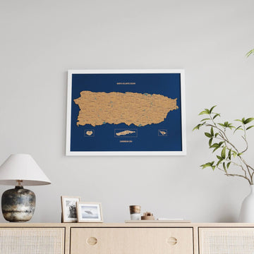 White-framed Puerto Rico cork map with a navy sea and island boxes, larger view above a sideboard