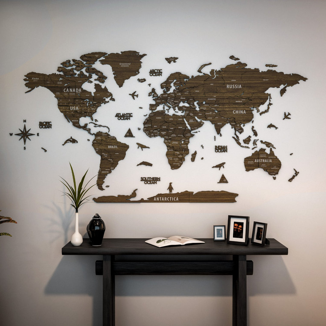World map on a wall above a dark wooden desk with decorative items.