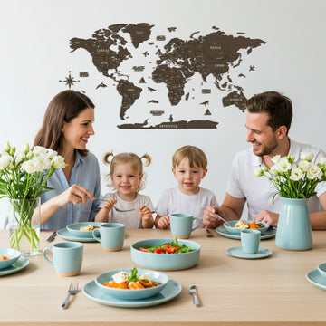 Betul wooden world map above a table where a family of four eats a meal with pale blue dishes
