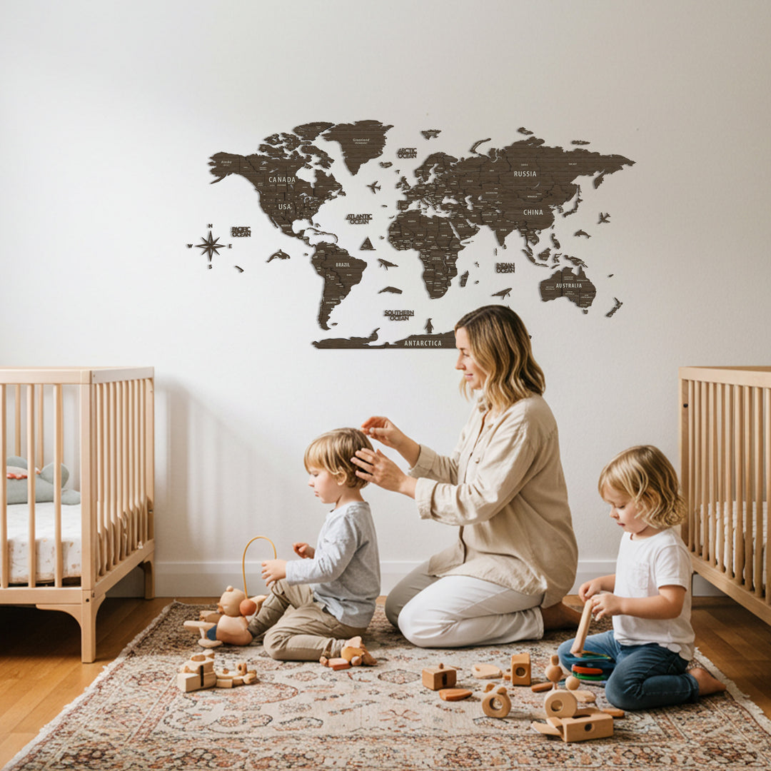 Woman and two children playing with colorful blocks in a room with a world map on the wall.