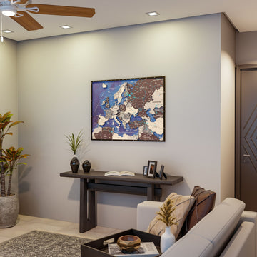 Nimbus wooden Europe map on a living room wall above a console table with a plant in view