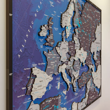 Side-angle close-up of layered Europe wooden map pieces with Spain, France, Germany and the Atlantic Ocean