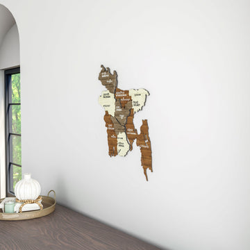 Bangladesh wooden wall map in a room corner next to a window, with a table and vase at the left