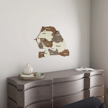 Small Senegal wooden wall map above a gray wavy-front dresser with a white vase