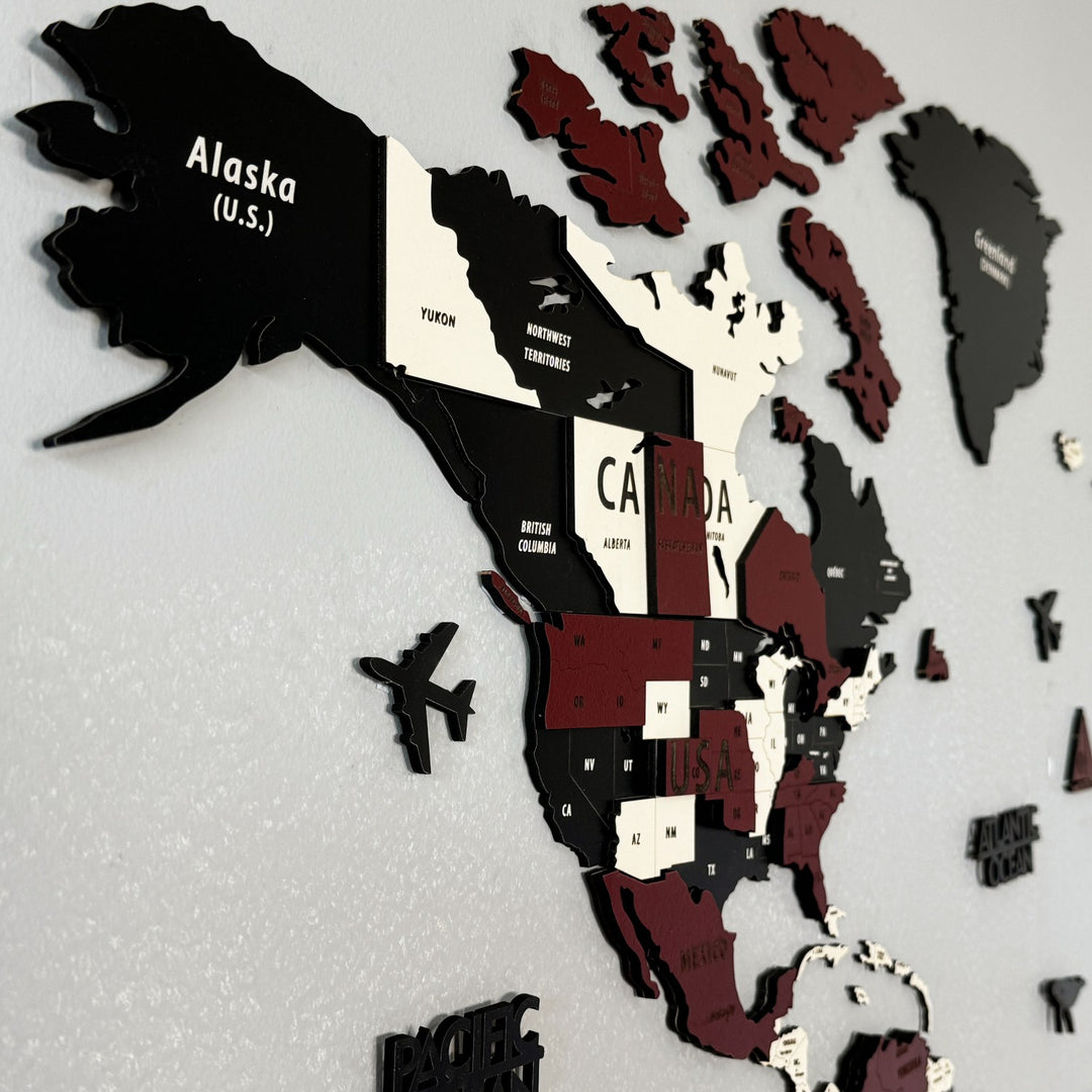 Close-up of Alaska, Canada and the Arctic islands on the burgundy wooden world map with an airplane marker