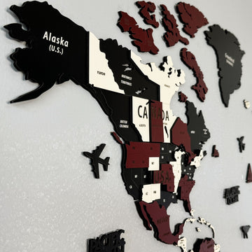 Close-up of Alaska, Canada and the Arctic islands on the burgundy wooden world map with an airplane marker
