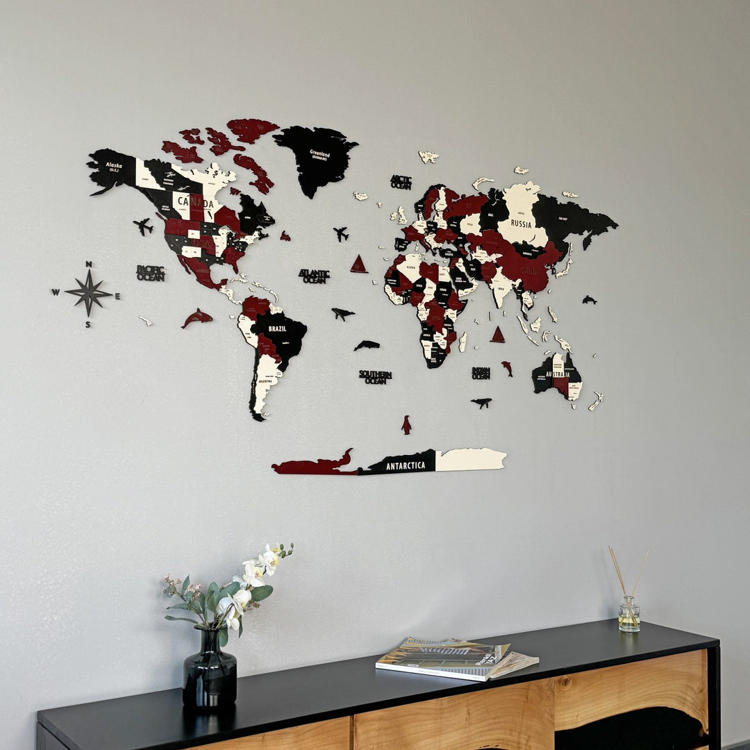 Burgundy wooden world map with country names, seen from a lower angle above a black sideboard