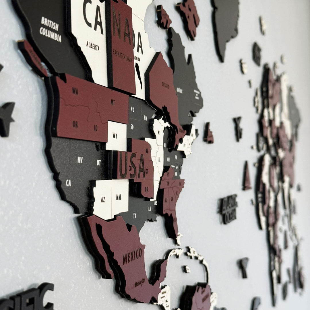 Angled close-up of the burgundy wooden world map showing Canada, the USA and Mexico in raised layers