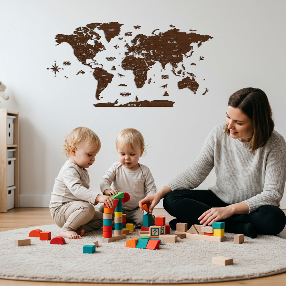 A woman and two children play with toys in a room with a wooden world map on the wall